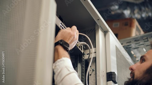 An engineer working on cluster console in an artificial intelligence server room photo
