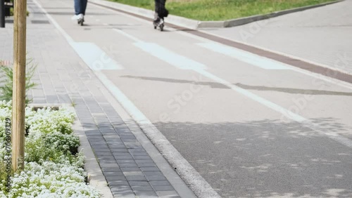Man and woman riding electric scooters on a bike path. Active lifestyle concept
