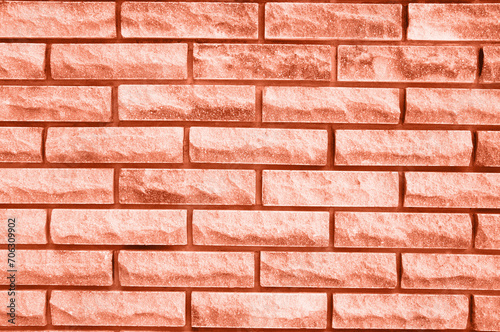 textured brick background in the color of 2024 peach fuzz. High quality photo