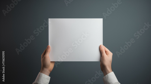 Hands holding a square paper leaflet presentation