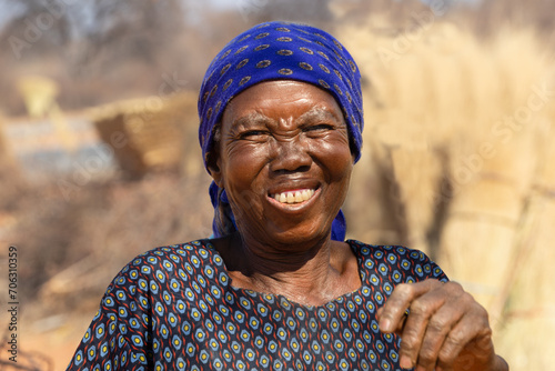 village happy old african woman , outdoors in a sunny day in the bush photo