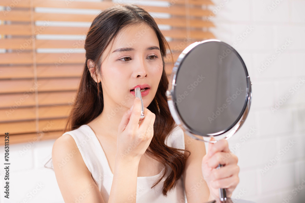 Beauty Asian woman using lipbalm in bedroom interior, lady taking care of her beautiful lips, Beauty Asian woman using lipbalm in bedroom interior, lady taking care of her beautiful lips,