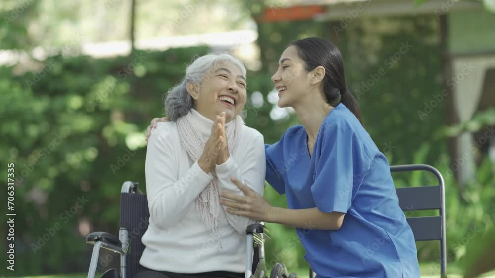 Happy patient is holding caregiver for a hand while spending time together outdoor. Happy patient is holding caregiver for a hand while spending time together outdoor.