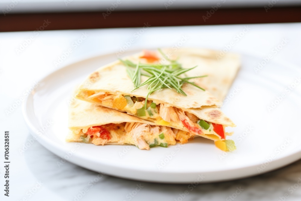 cheesy chicken quesadilla on a white plate cheesy chicken quesadilla on a white plate