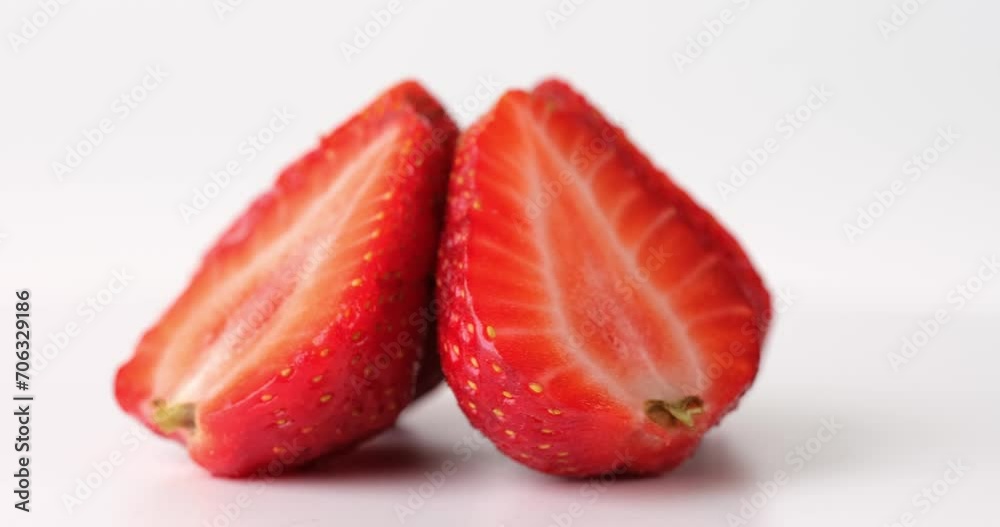 Slices of fresh strawberries rotating in circle on white background. Delicious fresh strawberries Slices of fresh strawberries rotating in circle on white background. Delicious fresh strawberries