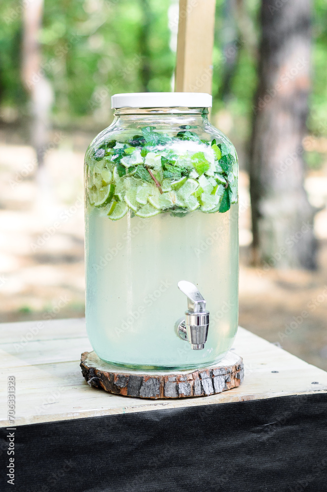 Homemade mojito in glass jar on wooden table. Homemade mojito in glass jar on wooden table.