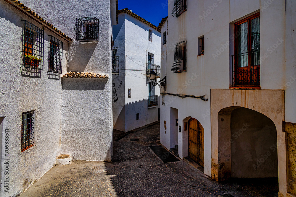 urban narrow street in the Spanish city of Altea on a summer day