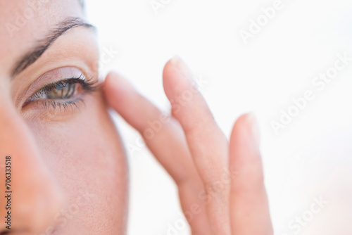 Extreme Close-up of Woman Touching Corner of her Eye
 photo