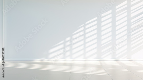 empty room with white wall and shadow sunlight. A bright white room with a warm white floor Interior of living minimal style with empty space for products presentation or text for advertising.