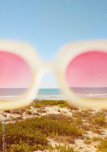 Cropped View of Rose-Colored Sunglasses with Beach in the background
