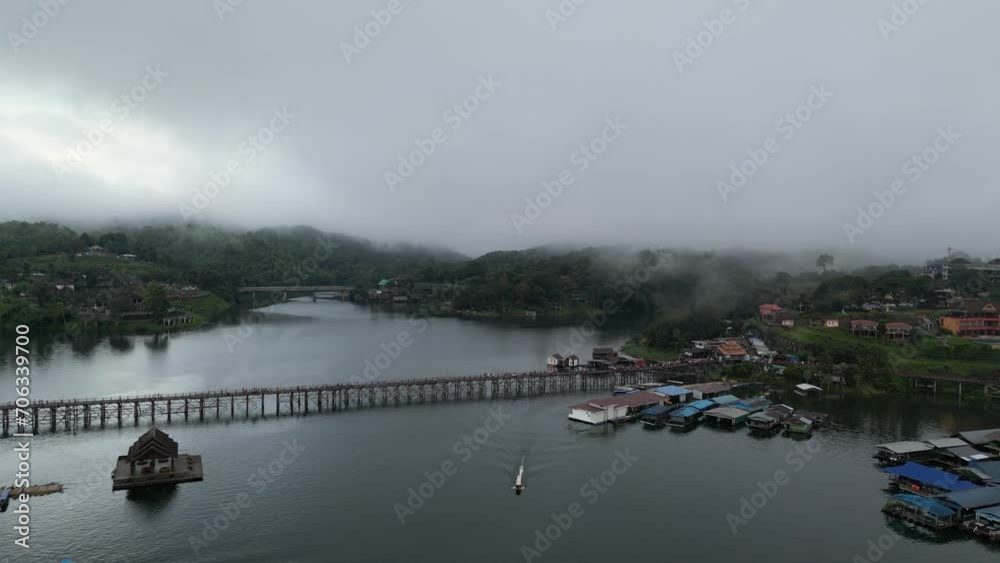 Mystical Dawn at mon bridge. Historical fog-covered Span with boats on the dam - Aerial perspective.