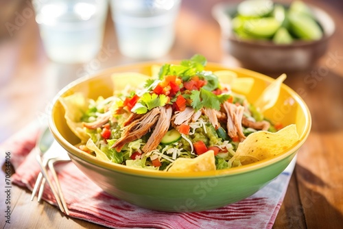 taco salad with a scoop of guacamole and tortilla strips