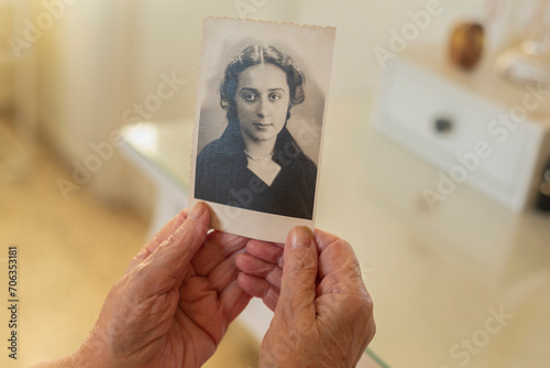 Point of view senior woman holding old photograph
 photo