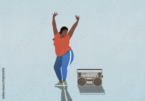 Carefree woman with arms raised dancing next to boom box on blue background
 photo