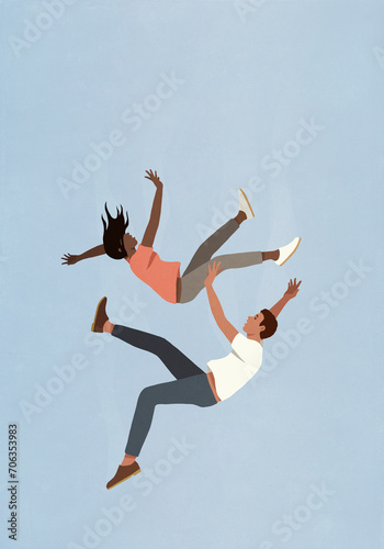 Couple falling midair against blue sky
 photo