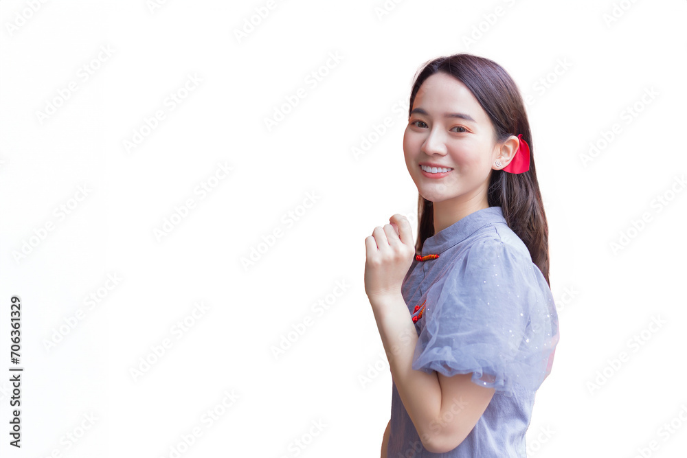 Young beautiful Asian woman in long hair wears grey dress stands among Chinese new year theme while isolated on white background. Young beautiful Asian woman in long hair wears grey dress stands among Chinese new year theme while isolated on white background.