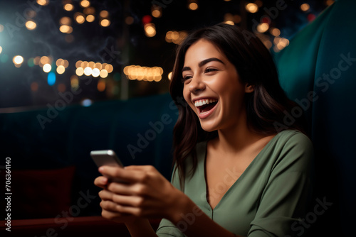 Smiling woman enjoying her smartphone while sitting on a couch, relaxed home environment.