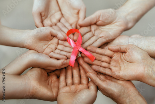 Foto Hands of women with pink ribbon