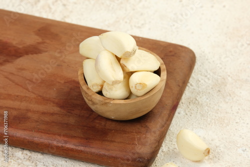 bawang putih kupas or peeled garlic on white background photo