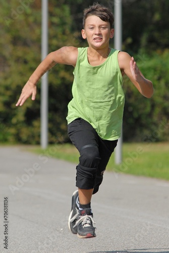 Kid running on urban park background.