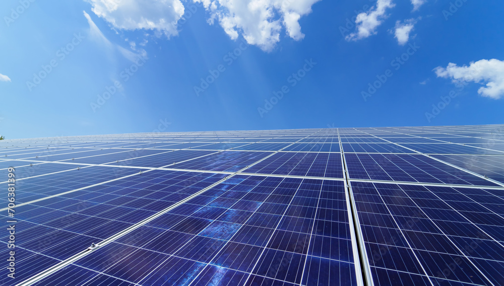 Witness the radiant display of renewable power as a solar panel gracefully soaks in the sunlight against a backdrop of a vivid blue sky.