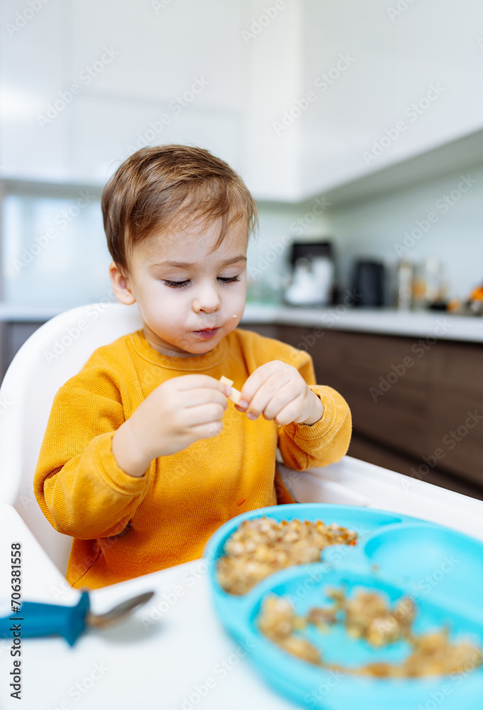 A little boy with a gleam of curiosity in his eyes, sits at a table, engulfed in his breakfast cereal, embarking on an imaginative breakfast adventure. A little boy with a gleam of curiosity in his eyes, sits at a table, engulfed in his breakfast cereal, embarking on an imaginative breakfast adventure.