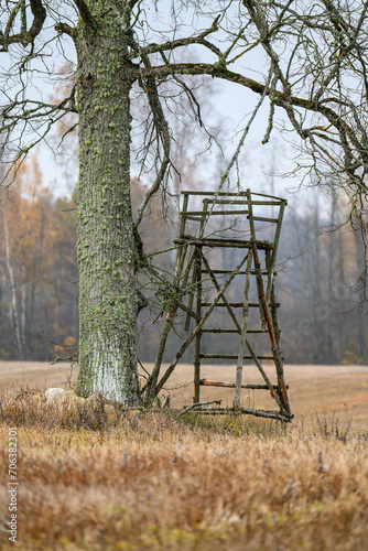 wooden hunting watch tower in late autumn fields