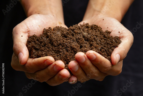 Front view of Human hands holding soil, tangan manusia lagi memegang tanah 