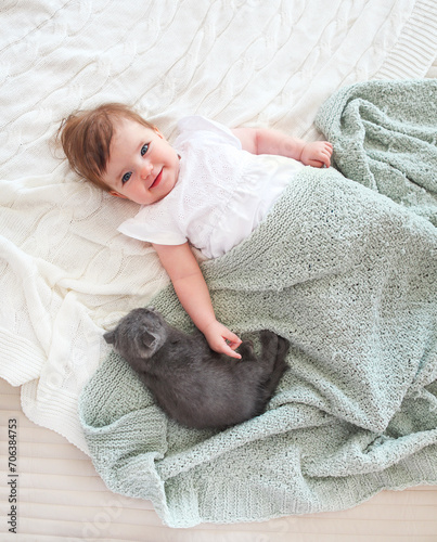 Close up portrait of a beautiful baby with kitten