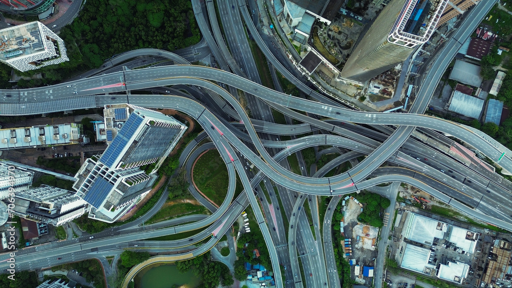 Obraz premium Aerial view of the expressway in Malaysia in the city of Kuala Lumpur, Penchala link. A birds eye view of a confusing traffic intersection. Architecture and urban planning of the capital.