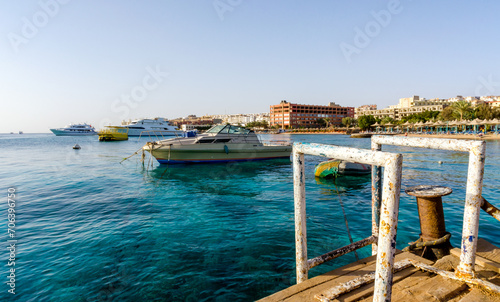 beach umbrellas and palm trees on the background of the red sea and ships in egypt