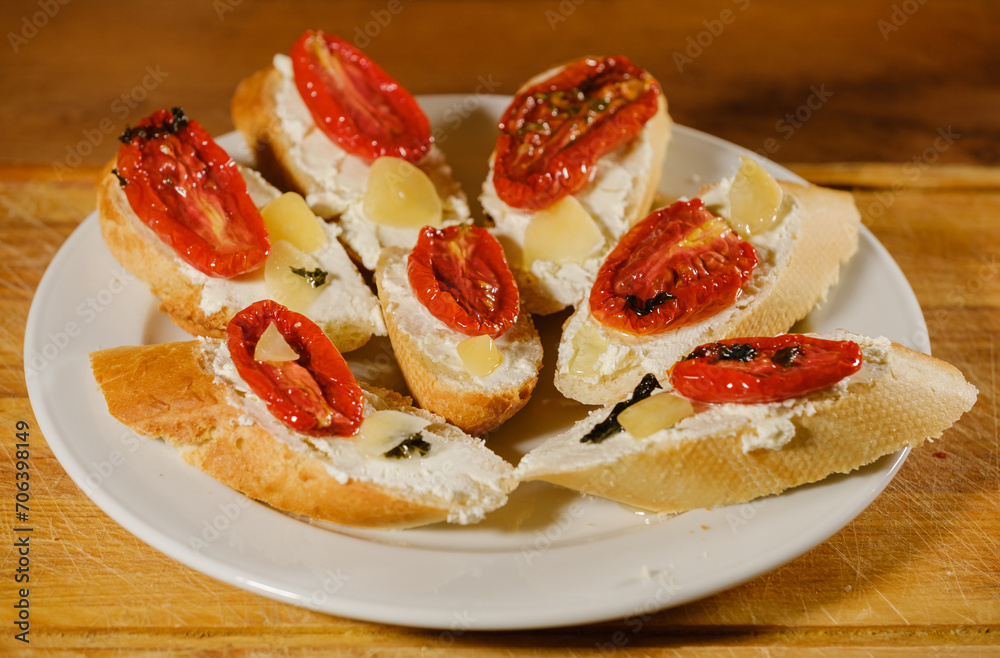sandwiches with sun-dried tomatoes and cheese on a plate on the table sandwiches with sun-dried tomatoes and cheese on a plate on the table