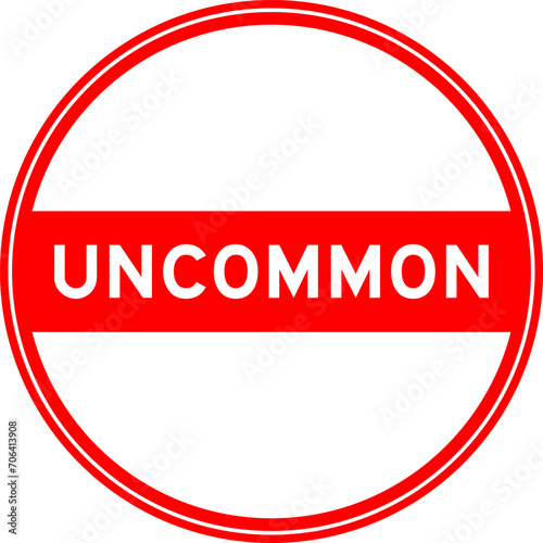 Red color round seal sticker in word uncommon on white background
