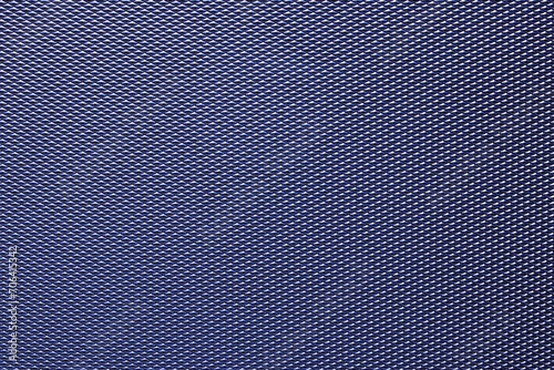 Seamless plastic texture background. Close-up of a detail from a blue metallic surface of a cosmetic bag. Beautiful backdrop. Macro.