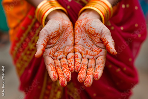 indian woman showing her painted hands with henna decoration