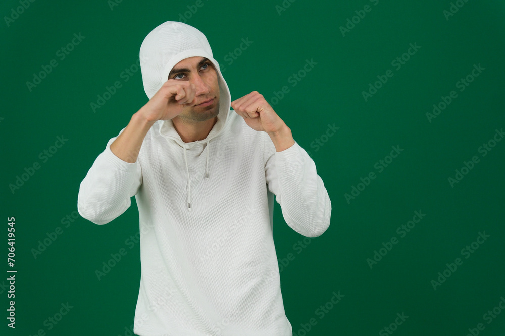Ready for fight concept. Portrait of serious man in boxing pose. caucasian man clenching fists in fight gesture on grey background copy space. High quality photo Ready for fight concept. Portrait of serious man in boxing pose. caucasian man clenching fists in fight gesture on grey background copy space. High quality photo