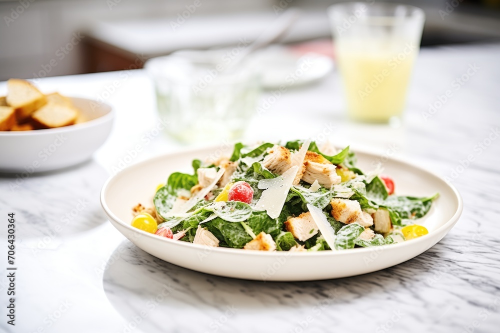 chicken caesar salad with gluten-free croutons on a marble countertop chicken caesar salad with gluten-free croutons on a marble countertop