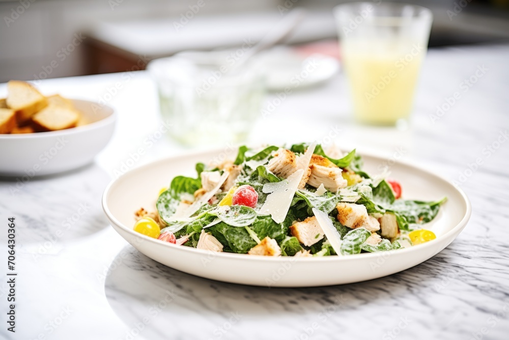 chicken caesar salad with gluten-free croutons on a marble countertop