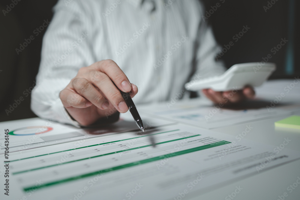 Numerical data is being presented for the accountant to calculate, male accountant working about financial with calculator at her office, Savings, Finances and economy concept, Numerical data is being presented for the accountant to calculate, male accountant working about financial with calculator at her office, Savings, Finances and economy concept,