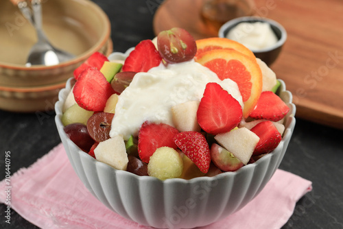 A Bowl of SLiced Fresh Fruit with greek Yoghurt Topping