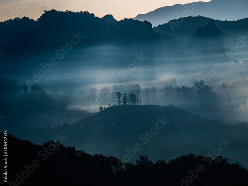 The rays of the morning sun through the fog in the mountains