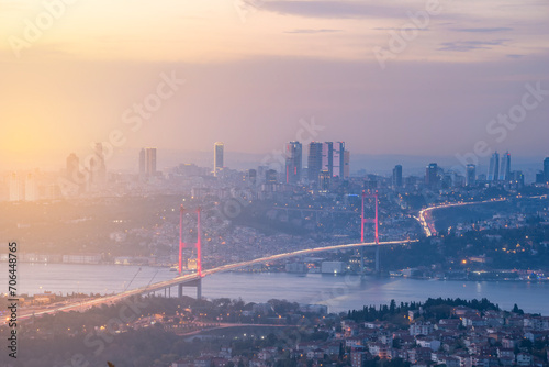 Istanbul Bosphorus Bridge at sunset and evening lights with colorful clouds in the sky photo