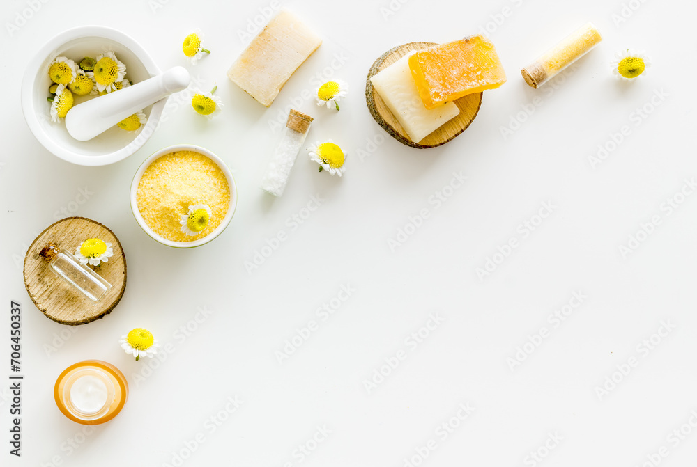 Chamomile flowers and herbs cosmetic products for skin care, top view Chamomile flowers and herbs cosmetic products for skin care, top view