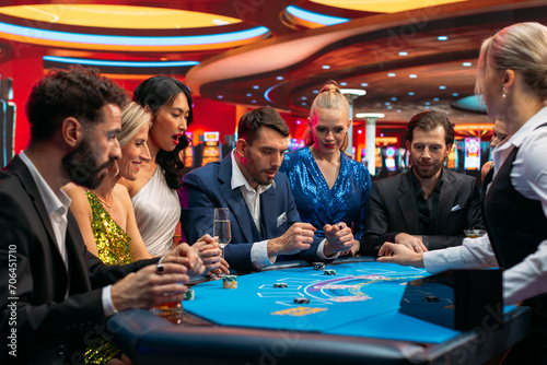 Cheerful Group of Rich People Gathered Around a Blackjack Table at a Casino. Cheerful Gamblers Waiting for Betting Good Hand Deal, Friends Congratulating the Winner