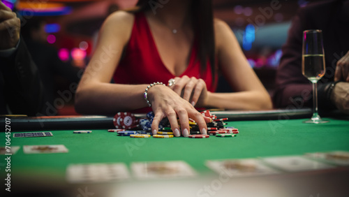 Photos Anonymous Glamorous Woman in a Evening Dress Collecting her Prize of Poker Chips in a Luxury Casino