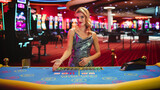 Portrait of a Female Croupier Looking at the Camera and Sharing the Results of a Baccarat Card Game. Beautiful Dealer in the Live Online Video Casino Revealing a Winning Hand