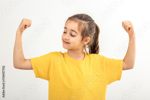 Funny girl hand flexing demonstrating biceps isolated on white background.