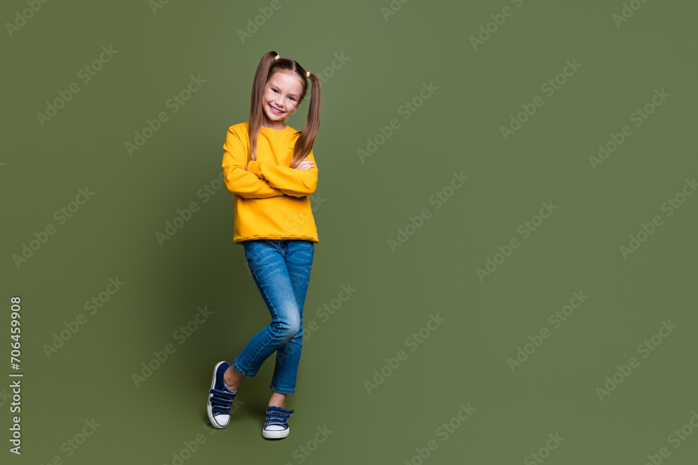 Full size photo of positive cheerful small kid with tails dressed yellow sweatshirt hold palms crossed isolated on khaki color background Full size photo of positive cheerful small kid with tails dressed yellow sweatshirt hold palms crossed isolated on khaki color background