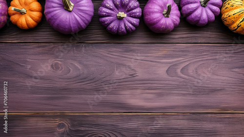 A group of pumpkins on a violet color wood boards