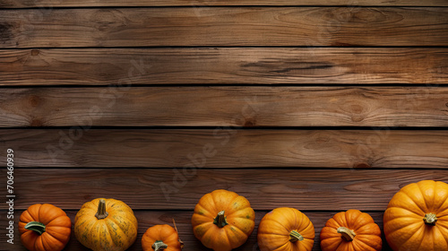A group of pumpkins on a tan color wood boards